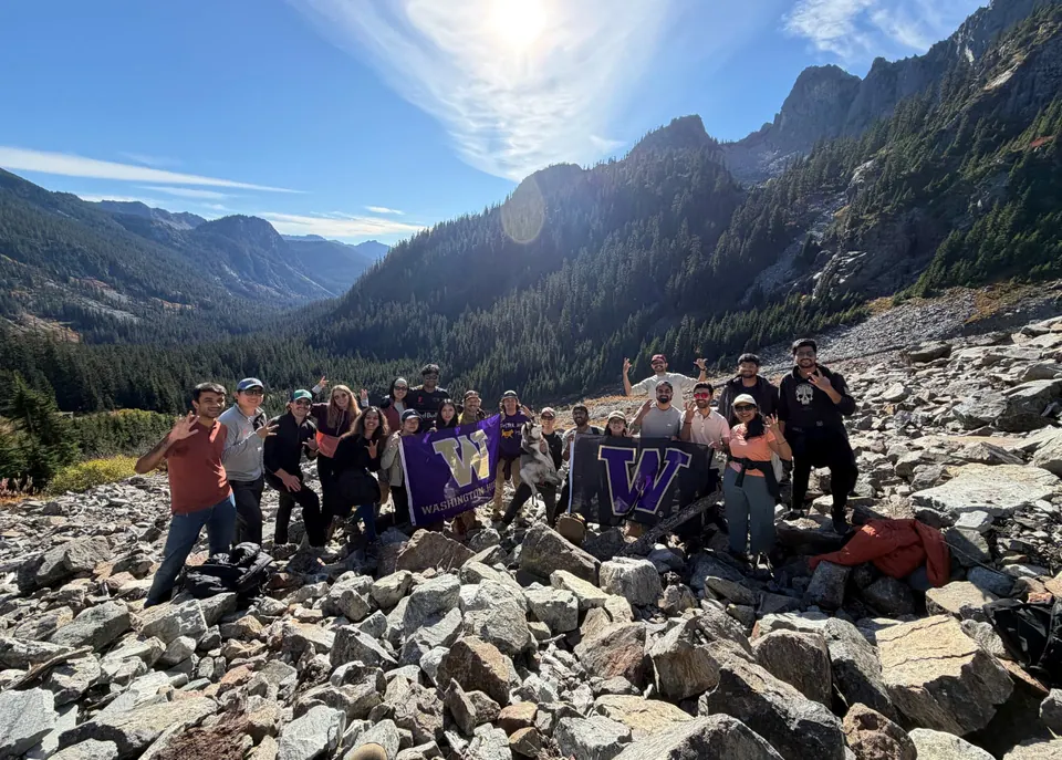 UW Foster MBA classmates and Husky puppy Cove on a rocky slope above Alpental at Snoqualmie Pass, Washington